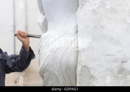 Stonemason using chisel  and mallet to create sculpture Stock Photo