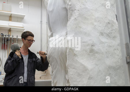 Stonemason using chisel and mallet to create sculpture Stock Photo