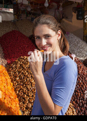 Portrait of young woman at market, Jemaa el-Fnaa Square, Marrakesh, Morocco Stock Photo