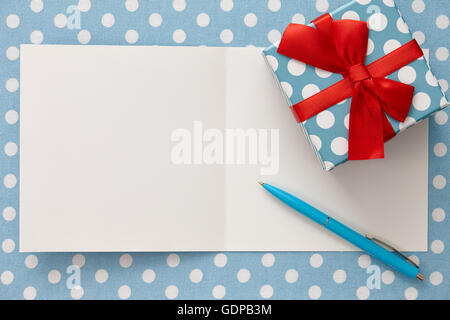 Greeting card with polka dot gift box and a pen Stock Photo
