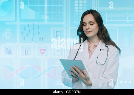 Female doctor using digital tablet, data on graphical screen behind her Stock Photo