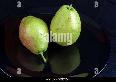 Fragrant pears . sweet fragrant flavor and aroma on black dish Stock Photo