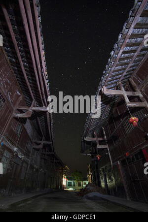 The Big Dipper seen through the alley way of a street in China. Big Dipper is colloquially known as the Seven Stars of the North Stock Photo