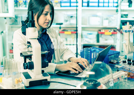 laboratory assistant analyzes of DNA sequence on the computer Stock Photo