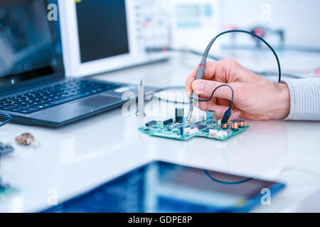 Using the microscope electronics laboratory Stock Photo