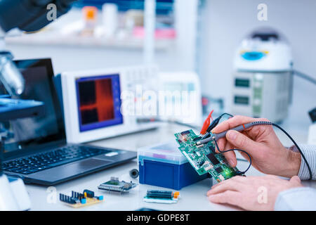 Using the microscope electronics laboratory Stock Photo