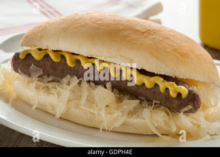 White bun with sauerkraut, sausage and mustard close up Stock Photo