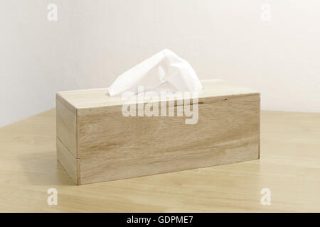tissue paper in wooden box holder on table Stock Photo
