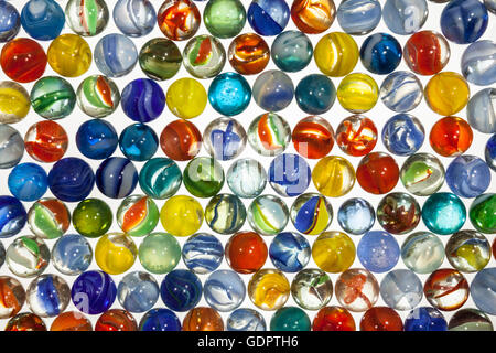 Colorful vintage toy marbles macro on white. Stock Photo