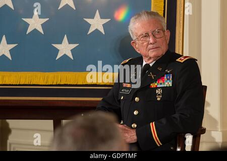 Retired U.S. Army Lt. Col. Charles Kettles listens to U.S President Barack Obama speak during the presentation ceremony for the Medal of Honor in the East Room of the White House July 18, 2016 in Washington, DC. Kettles is credited with saving the lives of 40 soldiers in combat operations near Duc Pho, Vietnam, on May 15, 1967. Stock Photo