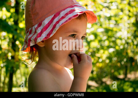 Portrait of a little girl who eats raspberry Stock Photo