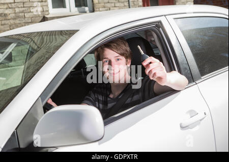 Teenage boy and new driver behind wheel of his car Stock Photo