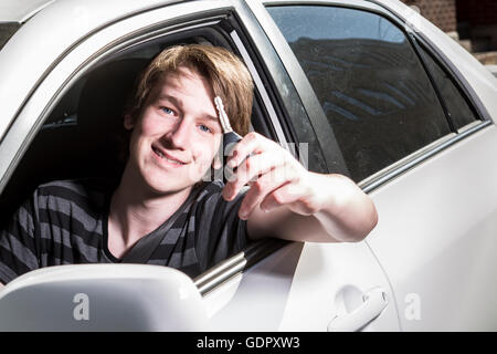 Teenage boy and new driver behind wheel of his car Stock Photo