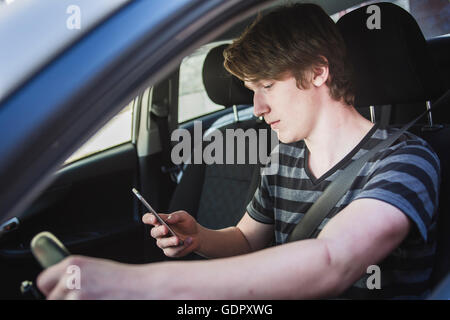 Teenage boy and new driver behind wheel of his car Stock Photo