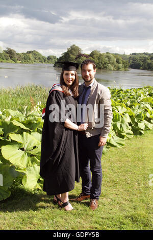 Young couple on graduation day Stock Photo