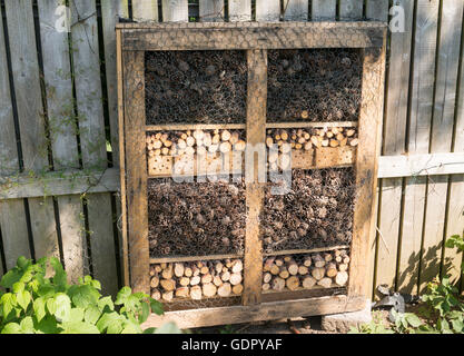 Insect or bug hotel on an allotment garden, made from recycled materials Stock Photo