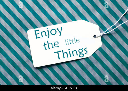 Label On Turquoise Wrapping Paper, Quote Enjoy The Little Things Stock Photo