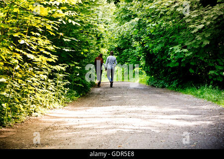 couple young walking along a road in the nature Stock Photo