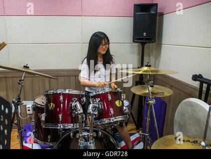 North korean teen defector in yeo-mung alternative school playing drums, National capital area, Seoul, South korea Stock Photo