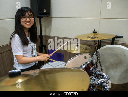 North korean teen defector in yeo-mung alternative school playing drums, National capital area, Seoul, South korea Stock Photo
