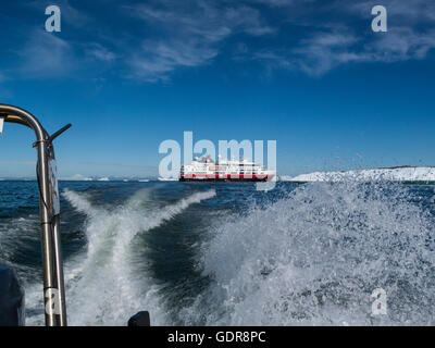 Polar Circle boat leaving MV Fram cruise ship to transfer passengers to shore from ship moored in Disko Bay Greenland on lovely July summers day Stock Photo