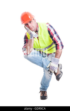Thoughtful constructor sitting on something and looking dissapointed as work problem concept isolated on white background Stock Photo