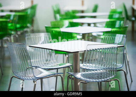 Rstaurant zone with colorful plastic chairs and tables in the lobby of the mall. Beautiful interior. Stock Photo