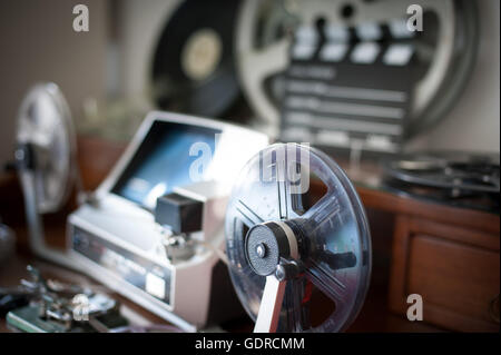 Super 8mm reel detail with desktop workspace for vintage movie editing out of focus in background Stock Photo