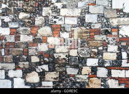 Old English Tradition wall built from flint, red brick ,stone and rock ideal for texture or background Stock Photo