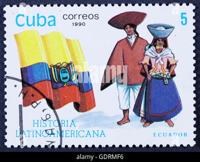 CUBA - CIRCA 1990: A stamp printed in Cuba, shows Flag and a couple dressed in national costumes from Colombia, with inscription Stock Photo