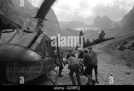 Rescue helicopter during a mission in the mountains, 1970 Stock Photo