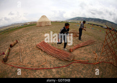 Hami, Hami, China. 16th July, 2016. Hami, China - July 16 2016: (EDITORIAL USE ONLY. CHINA OUT) Kazakh people live in yurts so that they can move to other plateaus conveniently. A traditional yurt (from the Turkic languages) or ger (Mongolian) is a portable, round tent covered with skins or felt and used as a dwelling by nomads in the steppes of Central Asia. The structure comprises an angled assembly or latticework of pieces of wood or bamboo for walls, a door frame, ribs (poles, rafters), and a wheel (crown, compression ring) possibly steam-bent. The roof structure is often self-supporting, Stock Photo