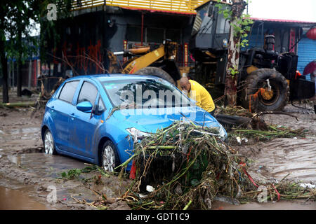 Jingxing, China's Hebei Province. 20th July, 2016. A man cleans a waterlogged street in Jingxing County of Shijiazhuang City, north China's Hebei Province, July 20, 2016. Continuous heavy rain hit north China's Hebei Province for three days, causing 14 people dead, 72 missing and affecting 1.995 million people. Credit:  Wang Baolong/Xinhua/Alamy Live News Stock Photo