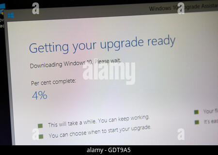 computer showing downloading windows 10 upgrade screen Stock Photo