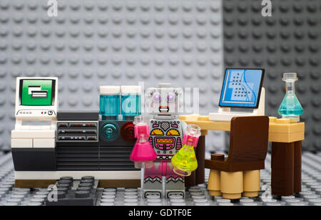 Tambov, Russian Federation - July 06, 2016 Lego robot - scientist minifigure with flasks in laboratory near computers. Stock Photo