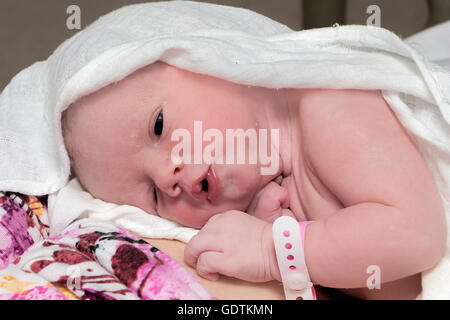 Newborn baby, girl, immediately after delivery resting with her mother Stock Photo