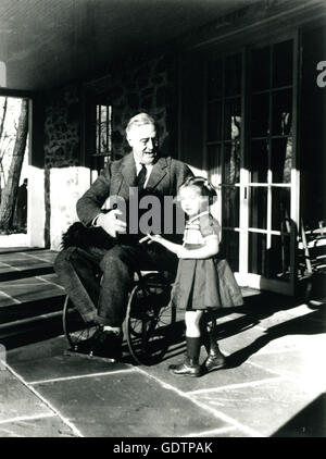 President Franklin D. Roosevelt with his dog Fala and Ruthie Bie, at Top Cottage. The photo is one of only two that show President Roosevelt in his wheelchair. Photo by Margaret Suckley. Stock Photo