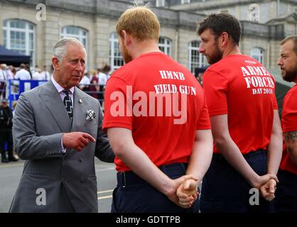 The Prince of Wales (left), Admiral of the Fleet, meets members of the Field Gun team during a visit to Her Majesty's Naval Base Devonport, on the third day of an annual visit to the South West. Stock Photo