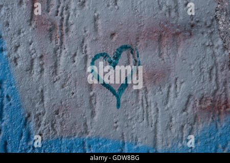 New, Graffiti, sprayed on a stone, Brick, wall, with the a letter E on the brickwork, with the black being sprayed over the top Stock Photo