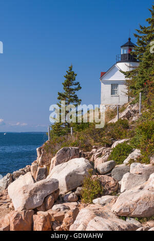 Bass Harbor Head Lighthouse on Mount Desert Island, Maine. Built in 1858, this lighthouse clings to the side of a red rock cliff Stock Photo