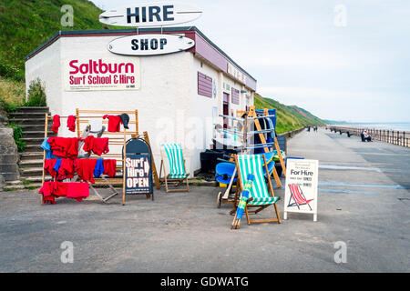 Surf School building on the promenade at Saltburn by the Sea Surf Equipment and siuts deckchairs and windbreaks for hire Stock Photo