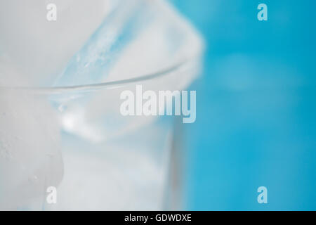 Ice cubes in a glass on blue background Stock Photo