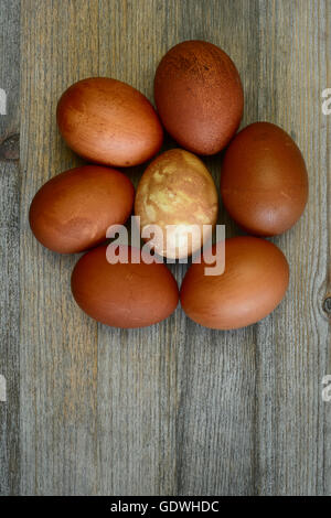 seven painted Easter eggs on a wooden background Stock Photo