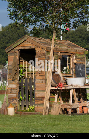 The Inside outside Rustic wooden potting garden shed personalised painted, nature, gardening, wooden, wood, plant, spring, green, agriculture, season, summer, tree, pot, flower, equipment, leaf, tool, work, and gardening tools at the RHS Royal Horticulutral Society 2016 Flower Show at Tatton Park, Knutsford, UK Stock Photo