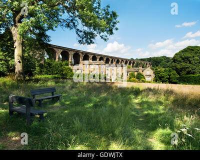 Benches in a Meadow below Denby Dale Railway Viaduct on the Penistone Line Denby Dale Village West Yorkshire England Stock Photo