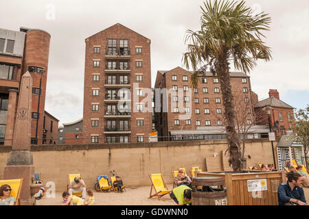 People relaxing on the pop up beach at the Quayside Seaside premises by the banks of the River Tyne at Newcastle upon Tyne Stock Photo