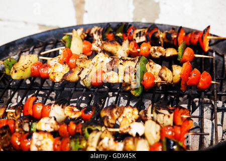 skewers of seafood grilling Stock Photo