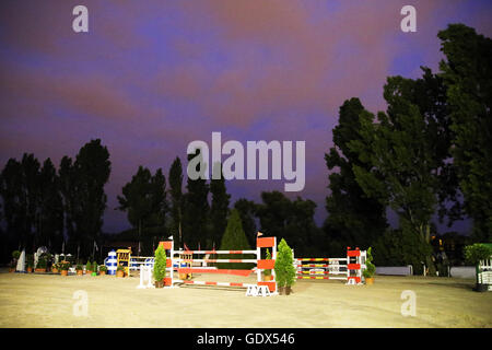 Equitation obstacles barriers at horse jumping racetrack by night Stock Photo