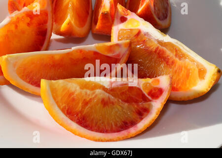 Fresh Blood Orange sliced on a plate showing details of the fruit Stock Photo