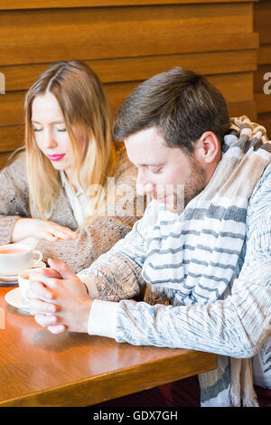 Family Praying Before Having Meal In Kitchen Together Stock Photo